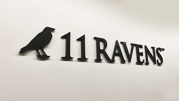 11 Ravens interior logo sign in a black color made of acrylic for corporate branding