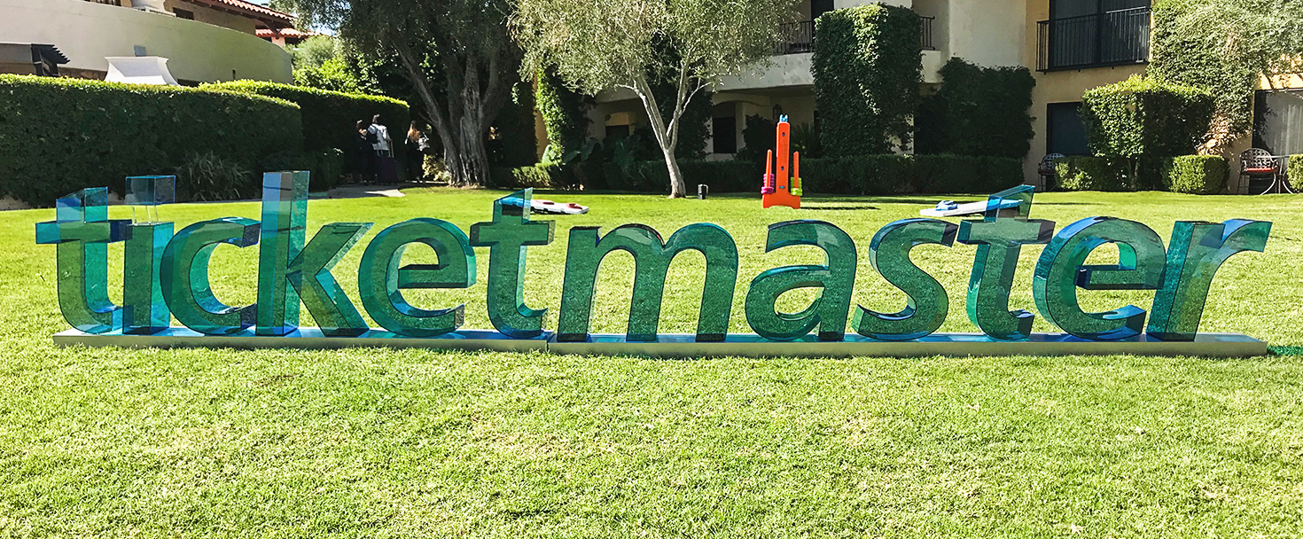 Ticketmaster custom 3D clear acrylic letters in green with a stand for business branding