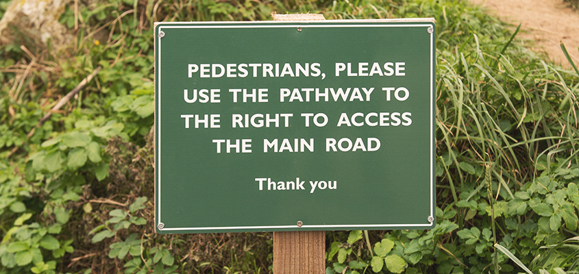 Directional message showcased on a sign board made of a sustainable marketing material