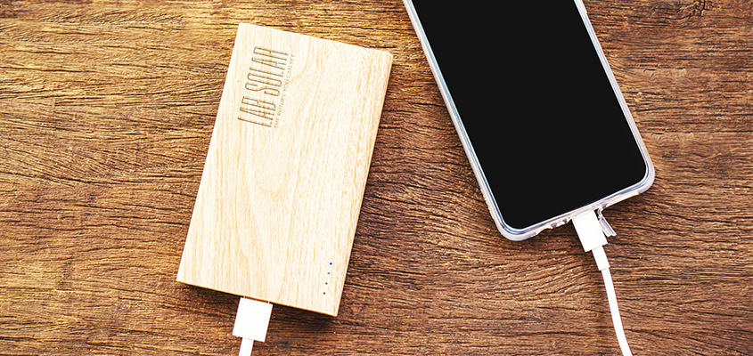 Bamboo power bank displaying the brand name