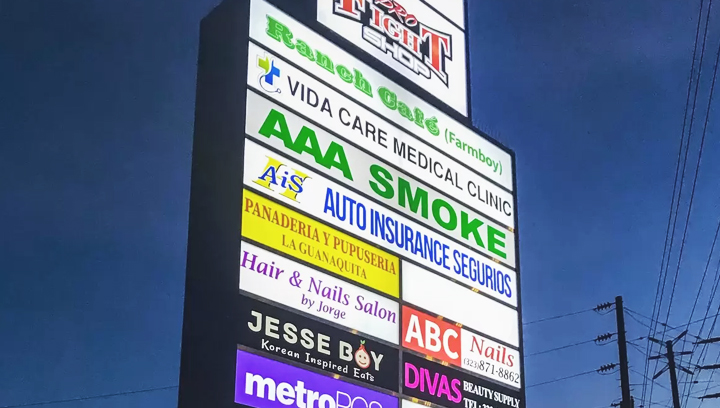 commercial center pylon sign displaying multiple brand names made of acrylic and aluminum