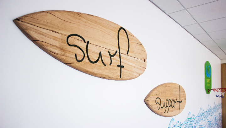 wall-mounted wooden signs in a surfboard shape for rustic style decorating