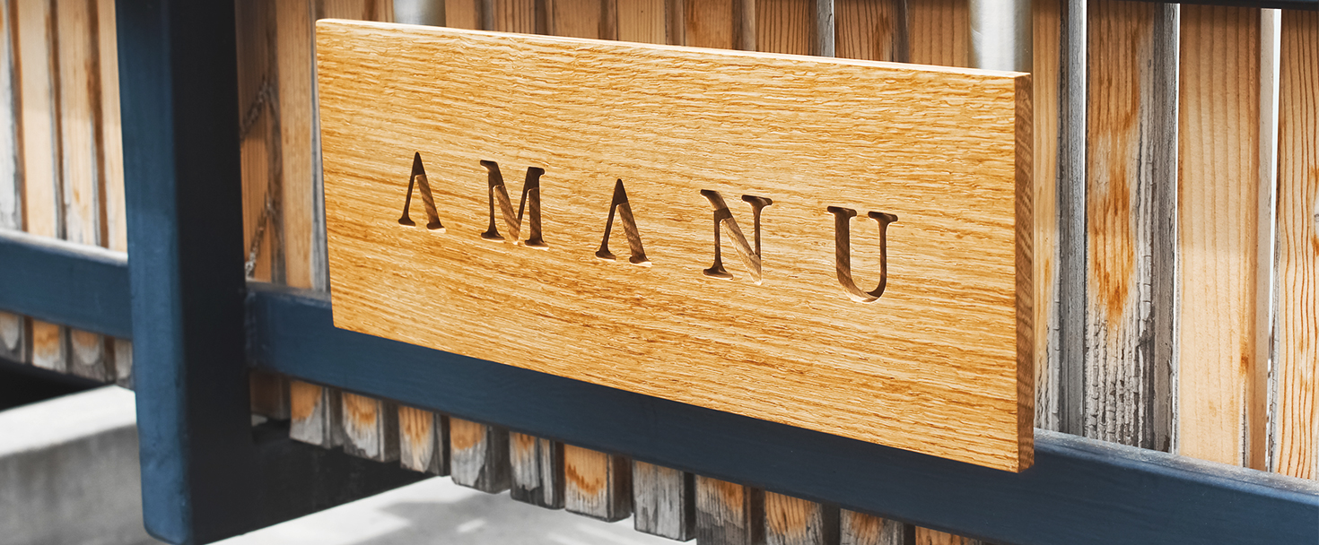 Amanu engraved custom wood logo sign in a rustic style for outdoor placement