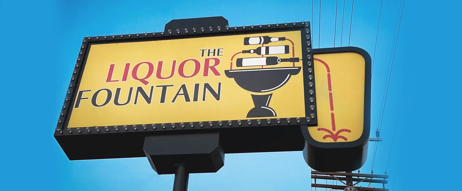 The Liquor Fountain plaza signage custom-made of aluminum and acrylic for brand visibility