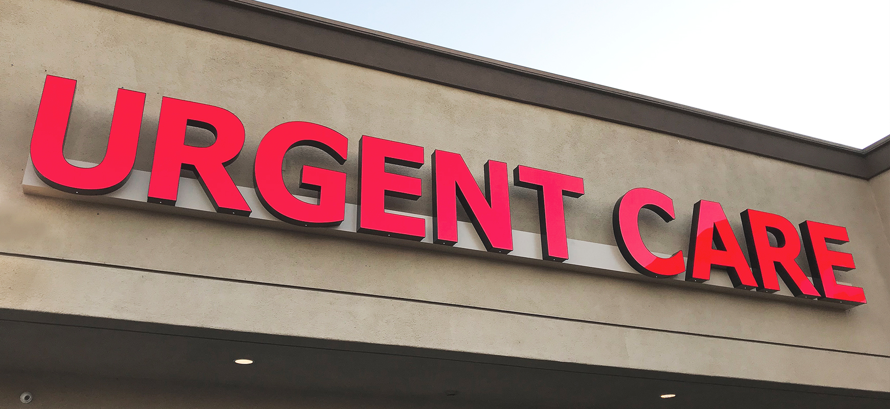 Urgent Care channel letter sign in red displaying the brand name made of aluminum and acrylic