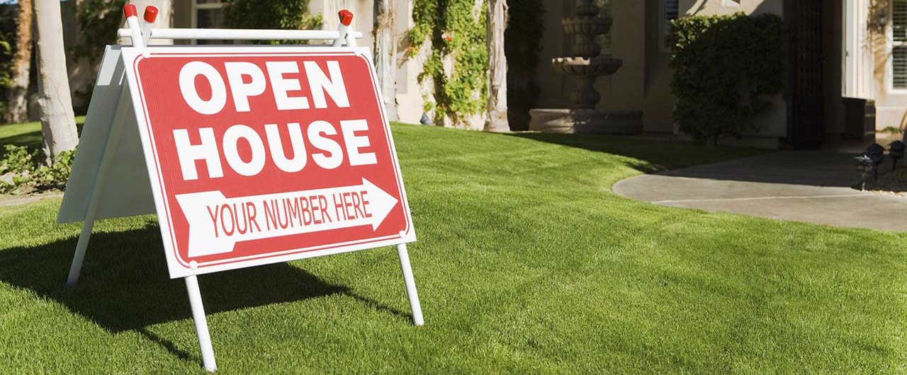 red and white open house a-frame yard sign on lawn