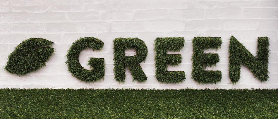 Green artificial ornamental grass sign