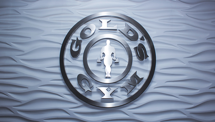 Gold's Gym metal interior logo sign in a round shape made of brushed aluminum