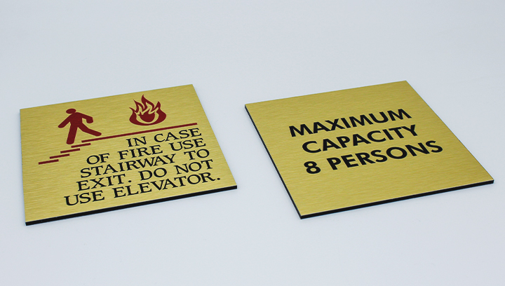 safety metal signs in yellow displaying warning messages made of brushed aluminum