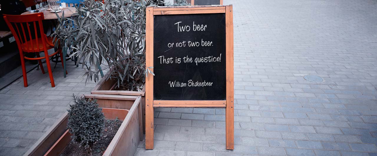 creative beer quote chalkboard a-frame on pavement