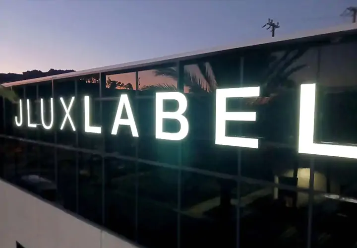 Channel letter sign for JLUXLABEL spelling out the brand name, made of lexan and aluminum
