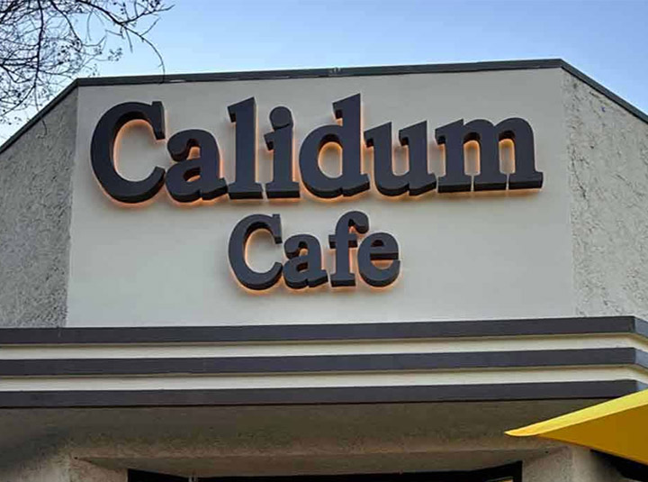 Channel letters for Calidum Cafe featuring back illumination, and installed outdoors