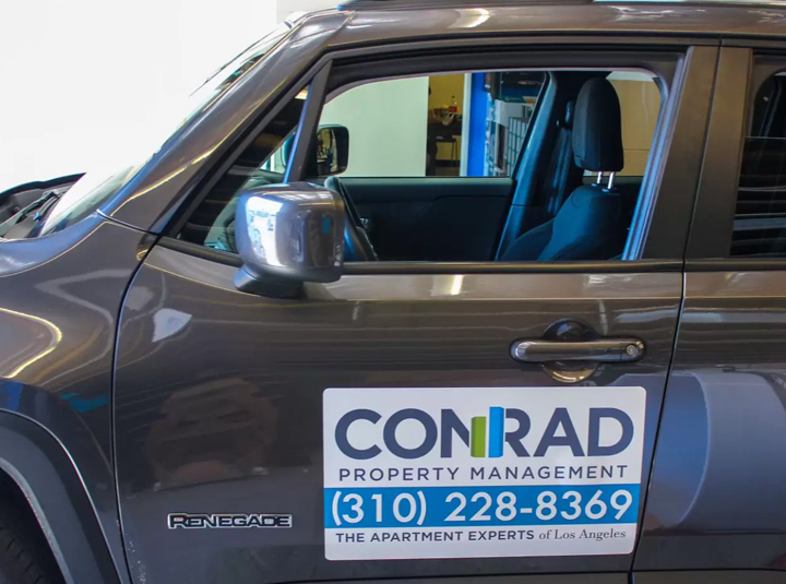 Conrad reusable car magnet displaying the brand name and contact details