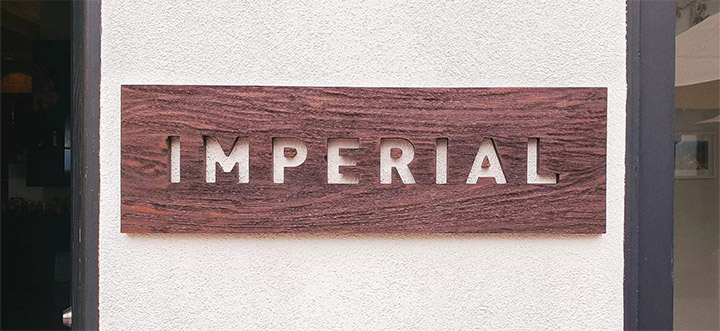 Imperial custom wood sign displaying the company's engraved name for store branding
