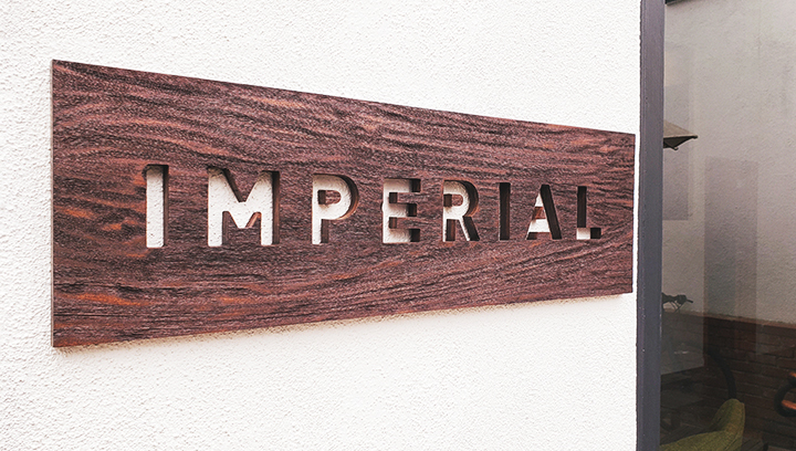 Imperial custom wood plaque with the company's engraved name for interior rustic branding