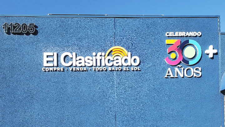 El Clasificado office PVC signs in bright colors on the building facade