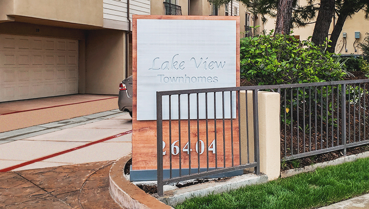 Lake View Townhomes front porch wooden sign in a monumental free-standing style