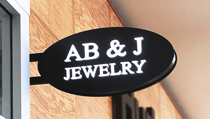 Ab & J Jewelry shopping center light box sign in an oval shape made of aluminum and acrylic