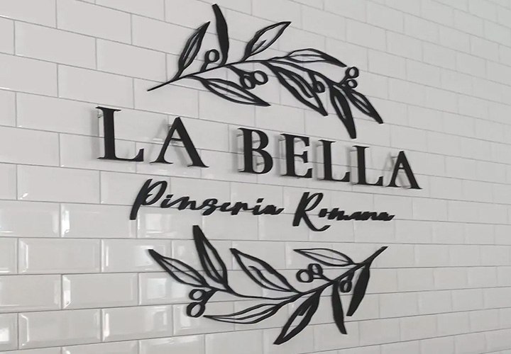 La Bella Pinseria Romana acrylic business sign painted in black and pin-mounted to the wall