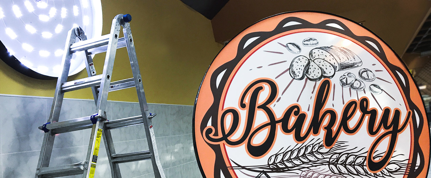 Bakery light box sign in a round shape made of acrylic, aluminum, and backlit vinyl