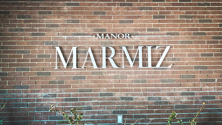 Manor Marmiz 3d aluminum letters displaying the company name on a brick wall