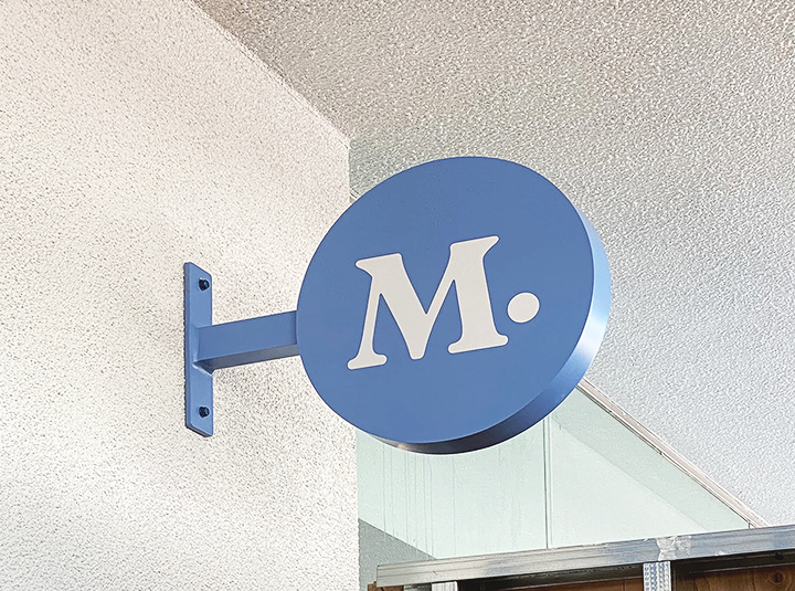 Modern Animal aluminum light box sign in a round shape displaying the company logo