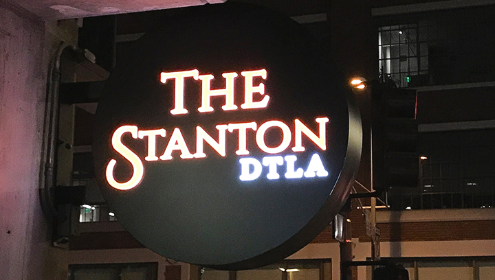 The Stanton DTLA partial lit light box sign in a round shape made of aluminum and acrylic