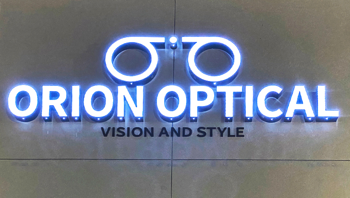 Orion Optical acrylic sign with illumination displaying the brand name and logo