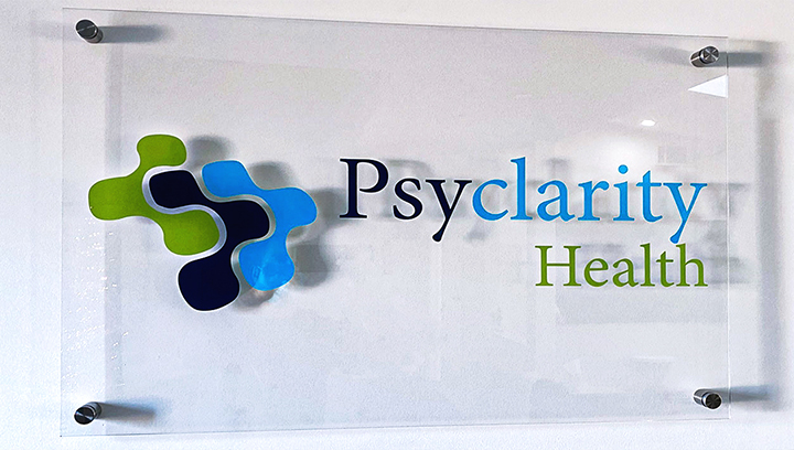 Psyclarity Health printed acrylic office sign showing the business name and logo for branding