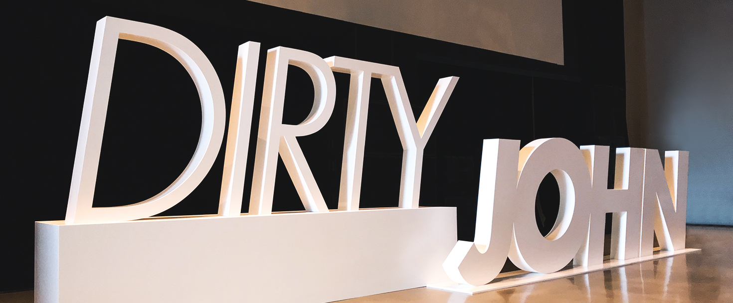 decorative PVC sign in white with big 3d letters displaying the words Dirty John