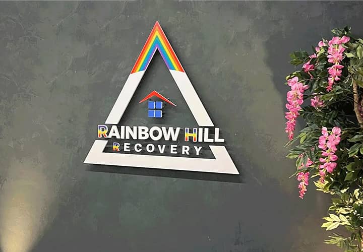 Rainbow Hill Recovery acrylic sign displaying the company name and logo for branding