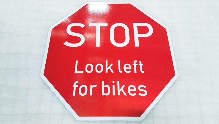 reflective aluminum sign in red displaying a stop warning for road traffic regulating