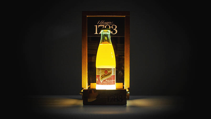 Schweppes wooden tabletop sign with illumination displaying the brand's bottle for advertising