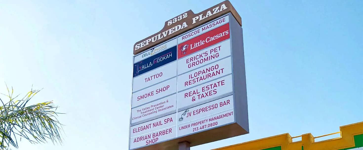 Sepulveda Plaza pylon sign displaying different brand names made of lexan and backlit vinyl