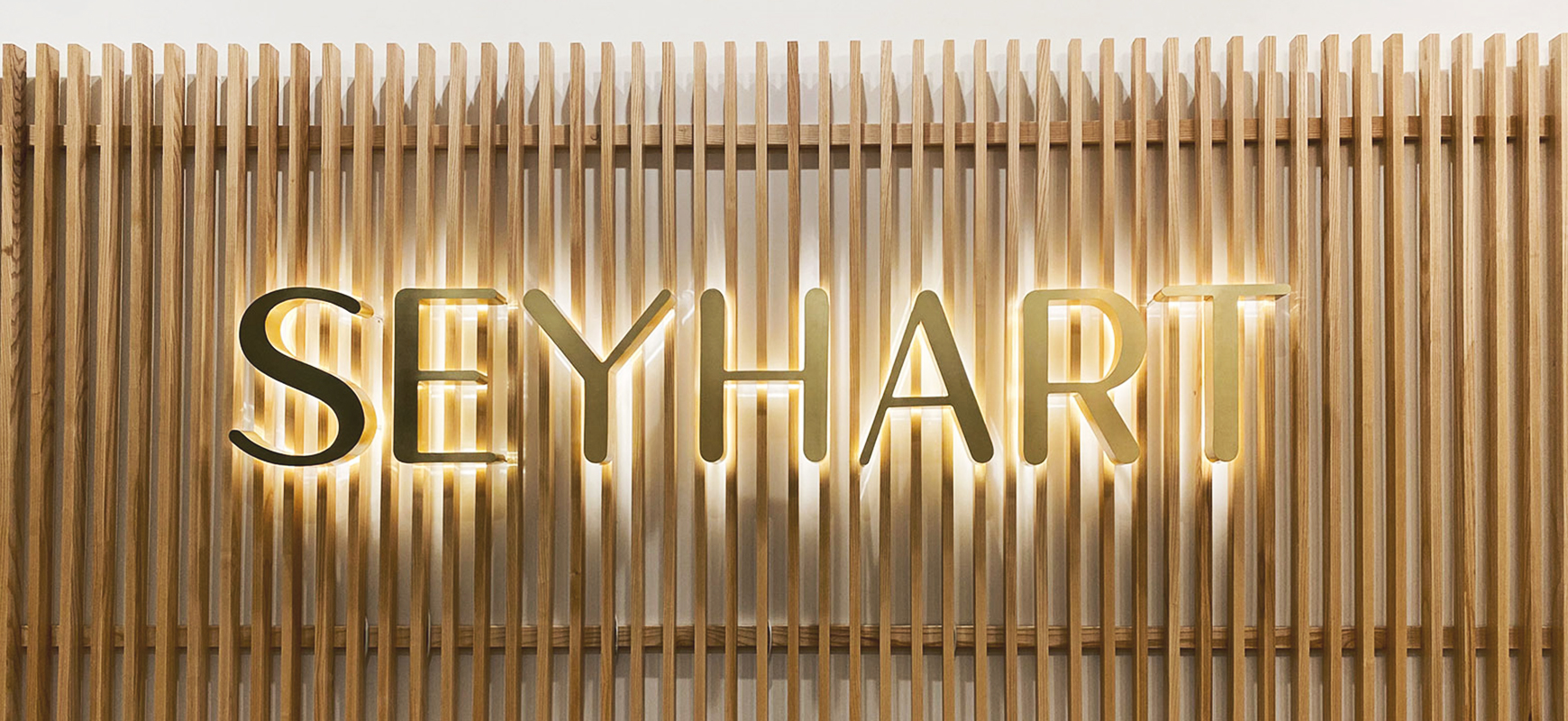 Seyhart channel letters in gold color displaying the brand name made of aluminum and acrylic