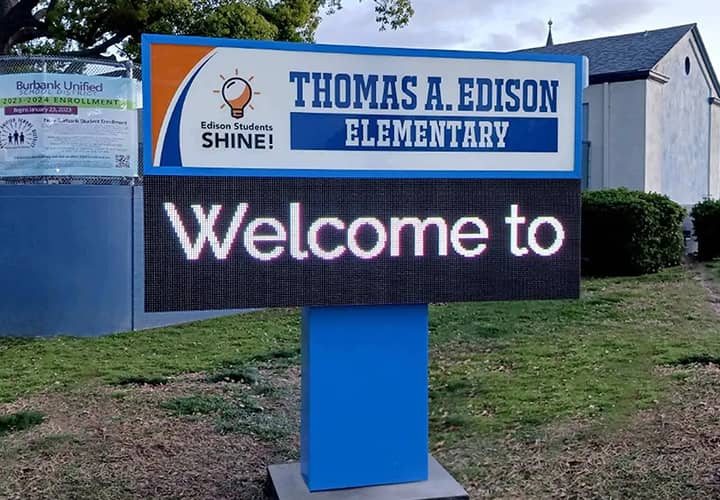 Thomas A. Edison Elementary school pylon sign in a monumental style with a welcoming note