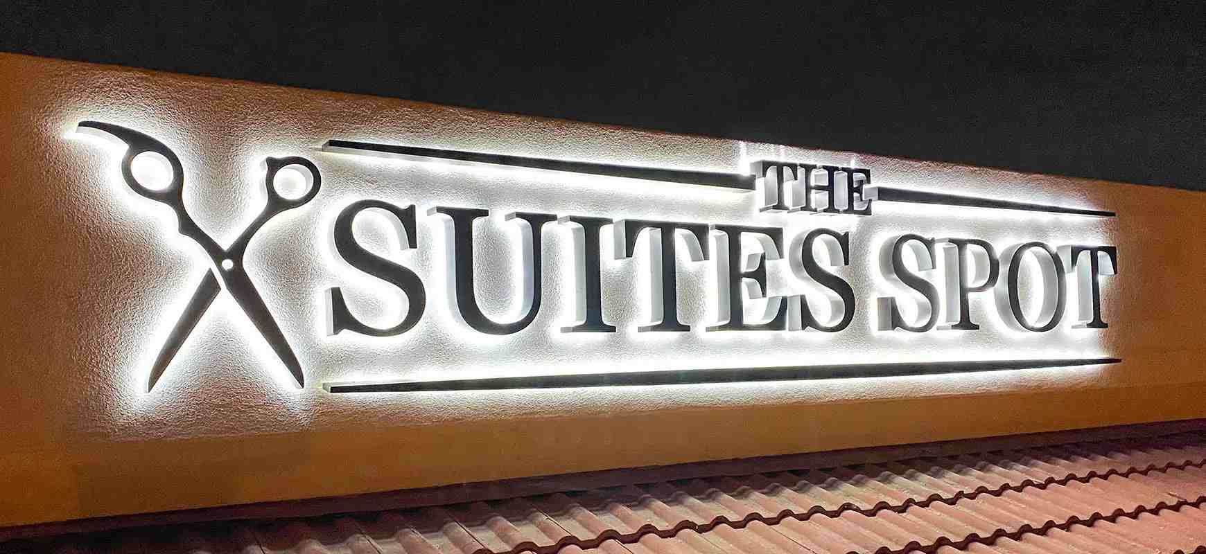 The Suites Spot backlit dimensional letter signage made of lexan and aluminum placed outdoors