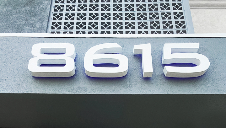 8615 reverse three dimensional letter signage displaying lit numbers for addresses