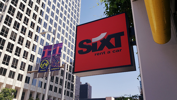 Sixt custom signage in a wall-blade style made of aluminum and acrylic for exterior branding