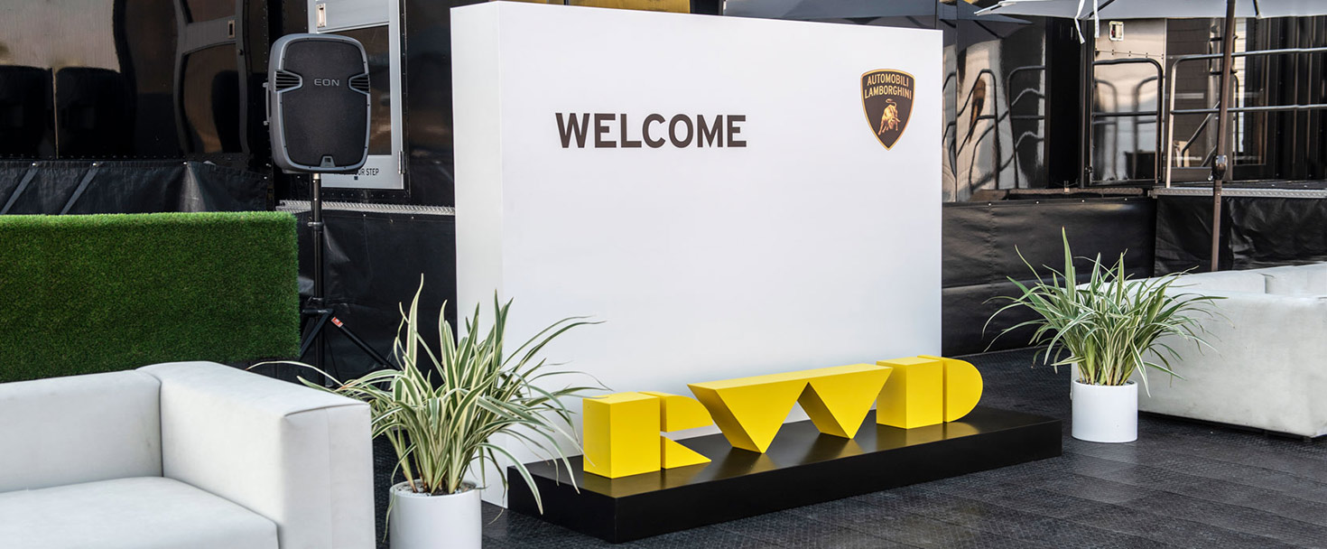 Lamborghini custom sigange with a branded wall and yellow letters made of aluminum and wood