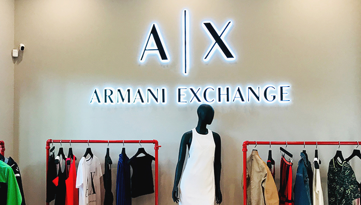 Armani Exchange backlit sign displaying the brand name and logo made of aluminum and acrylic