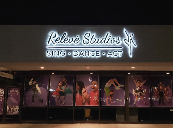 Releve Studios light up signs of the backlit logo and brand name in aluminum letters