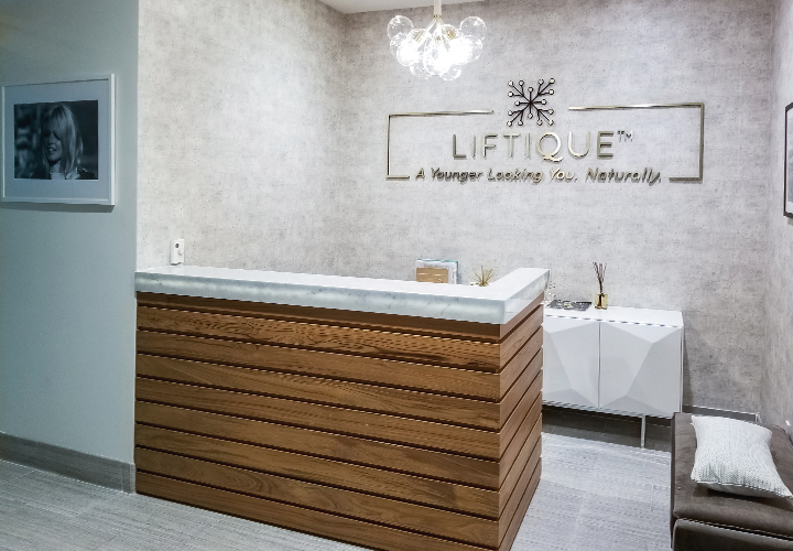 Liftique reception area design with lighted accents for branding