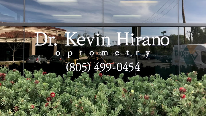 Dr. Kevin Hirano vinyl lettering with the brand name and phone number in white opaque vinyl