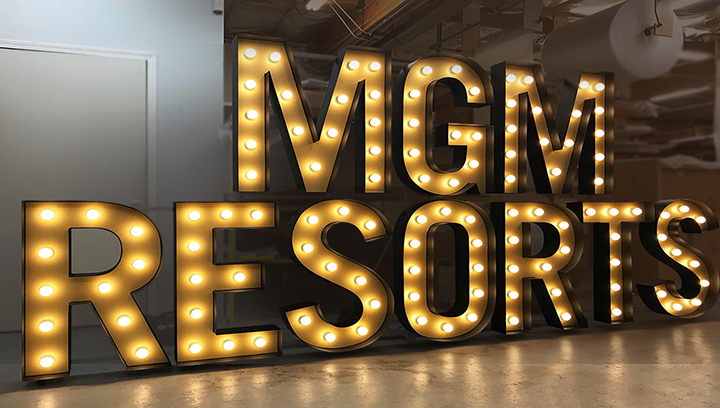 Light up signs featuring large freestanding letters for MGM Resorts in a marquee style