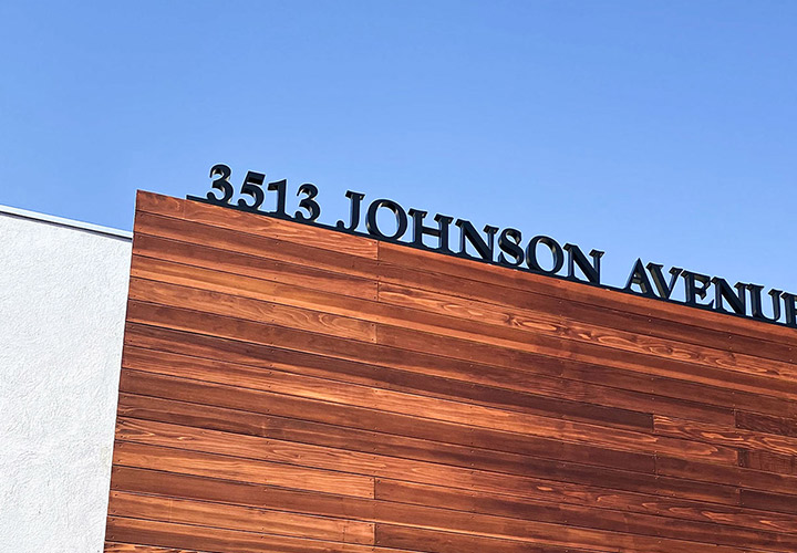 The Johnson Avenue custom signage displaying the business address in black acrylic
