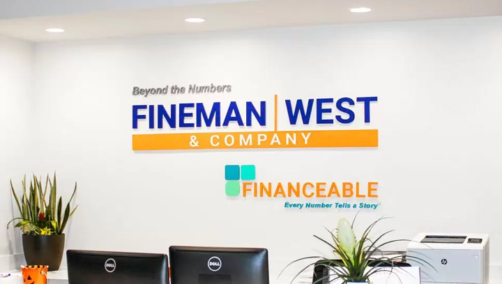 Fineman & West Company office reception sign with the company name and logo made of acrylic