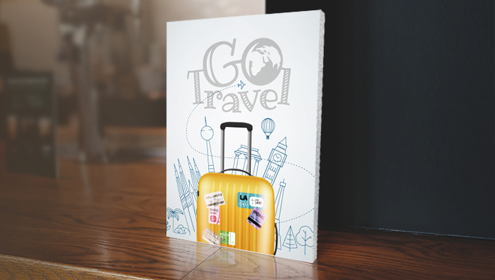 easel back foam core sign with travel theme graphics displayed on the table