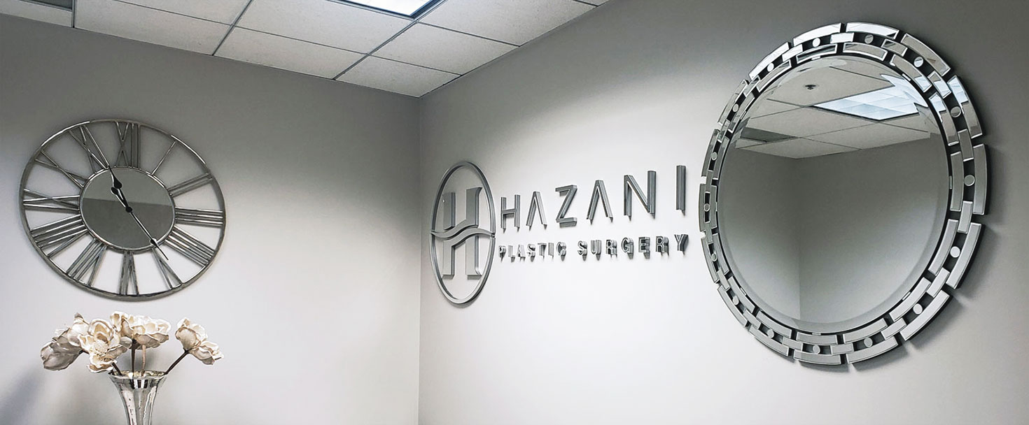 Hazani Plastic Surgery acrylic lobby sign displaying the company name and logo