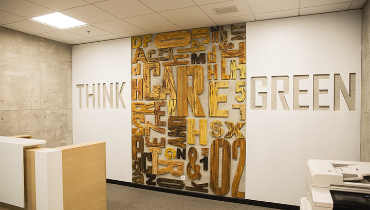 Accent wall adorned by a custom wooden lobby sign